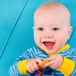 funny-baby-boy-on-blue-knitted-blanket-picture-id512000286