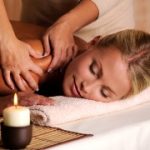 Masseur doing massage on female shoulder in the beauty salon