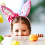 Happy easter! funny child girl with rabbit ears and   eggs