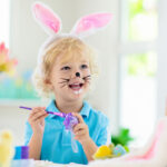 Kids on Easter egg hunt. Children dye eggs.