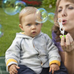 Mother and baby playing bubbles